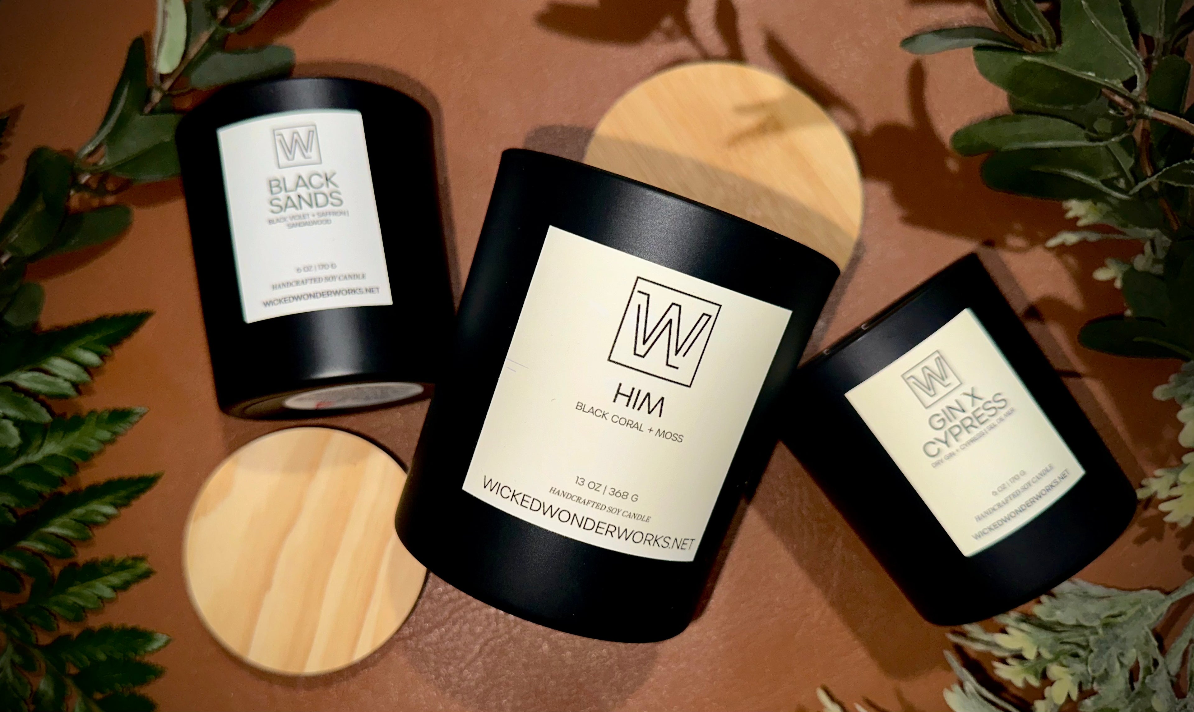 candles with bamboo lids and plant leaves